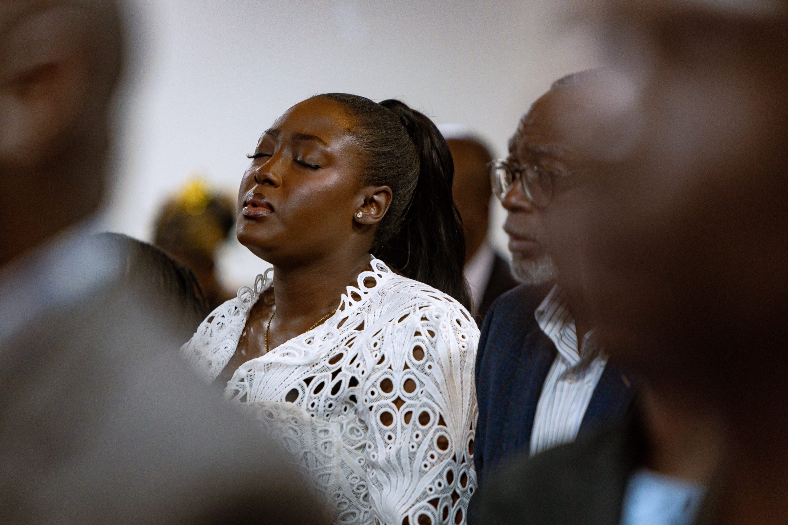 A worshipper in a reflective moment at Living Water Parish